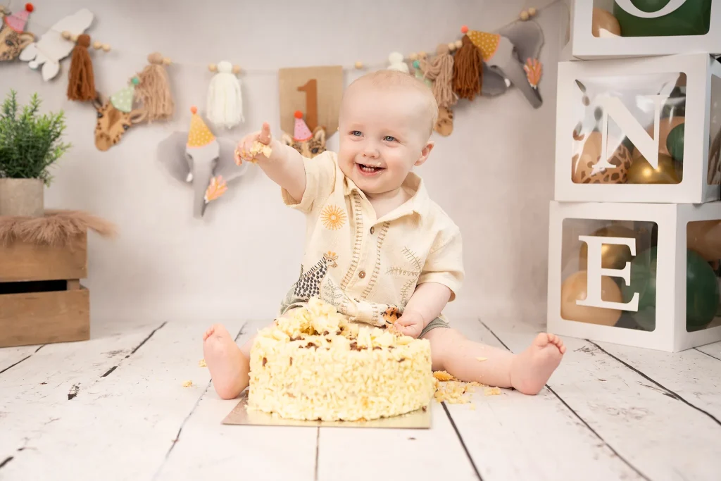 baby with cake on his finger during shoot in Longton