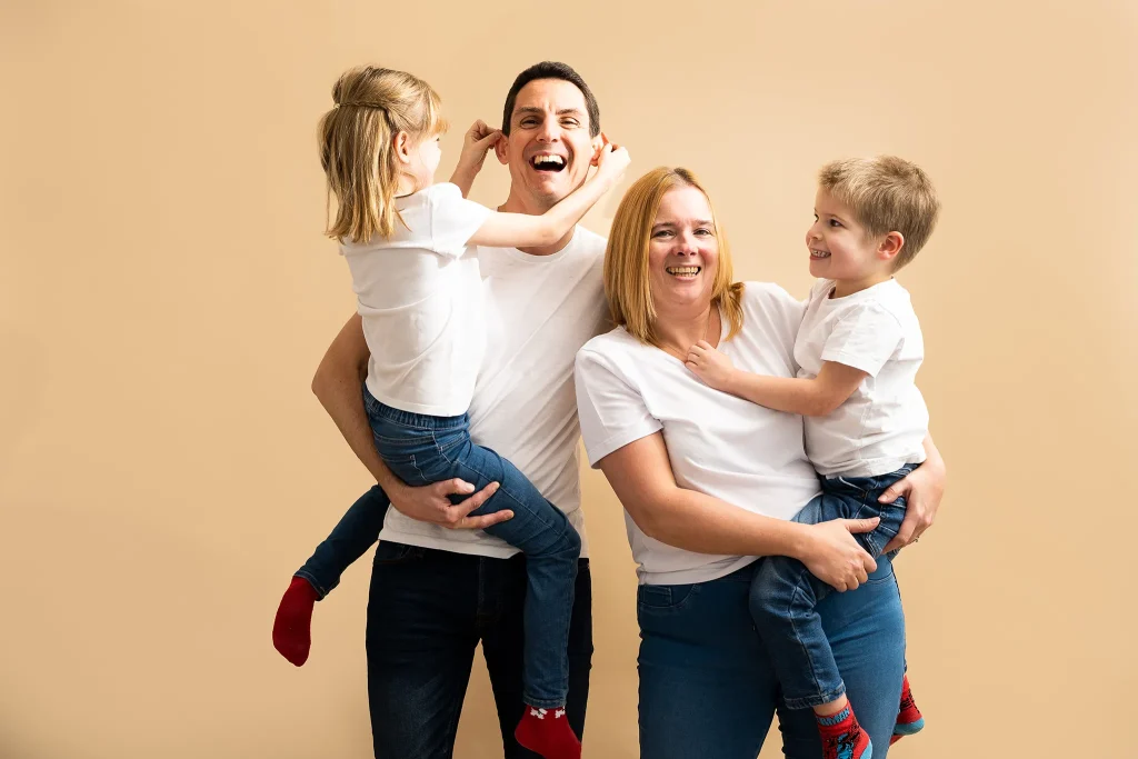 Girl playing with Dad's ears in family photo shoot in Preston